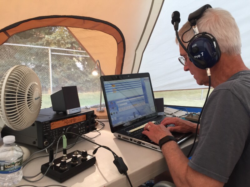 An amateur radio operator at a 40 meter SSB Field Day station